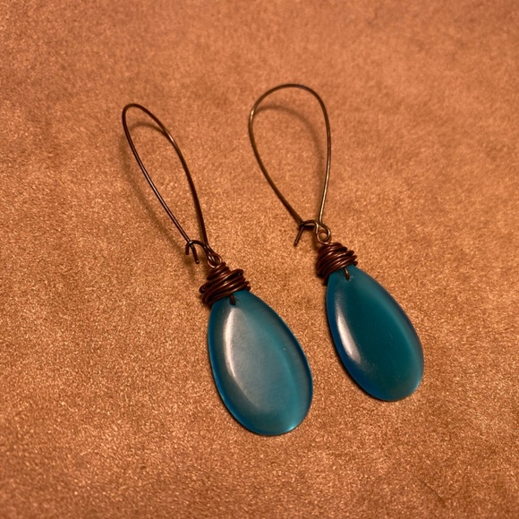 Peacock colored drop earrings with brass colored metal hoops. - Picture 3 of 3